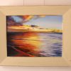 A framed original oil painting of a sunset on the Indian Ocean