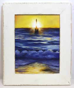 A framed original oil painting depicting a sunset at Perths popular Cottesloe beach